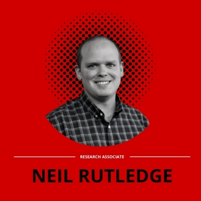 black and white Portrait of blog author, Neil Rutledge, on a red background.